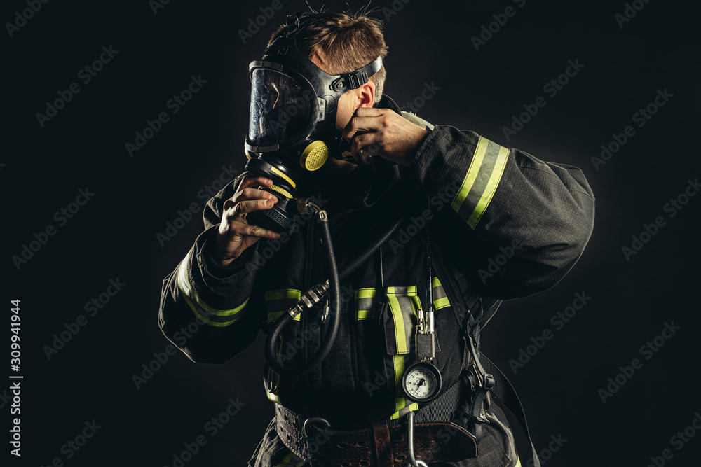 strong firefighter in protective suit and helmet use special equipment for preventing fire and save people and animals from fire strong firefighter in protective suit and helmet use special equipment for preventing fire and save people and animals from fire