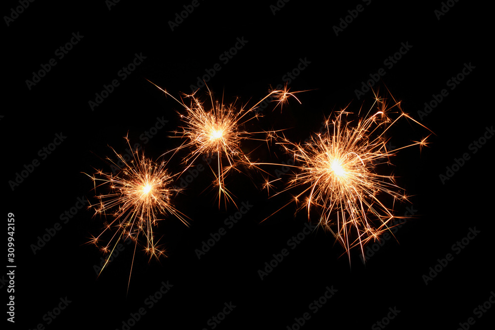 Three sparklers firework on black background. Christmas celebration.
