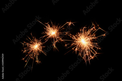 Three sparklers firework on black background. Christmas celebration.