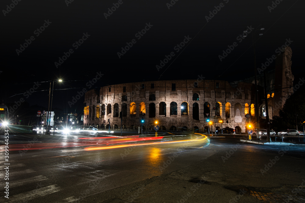 light trails from cars and buses in front of the coliseum