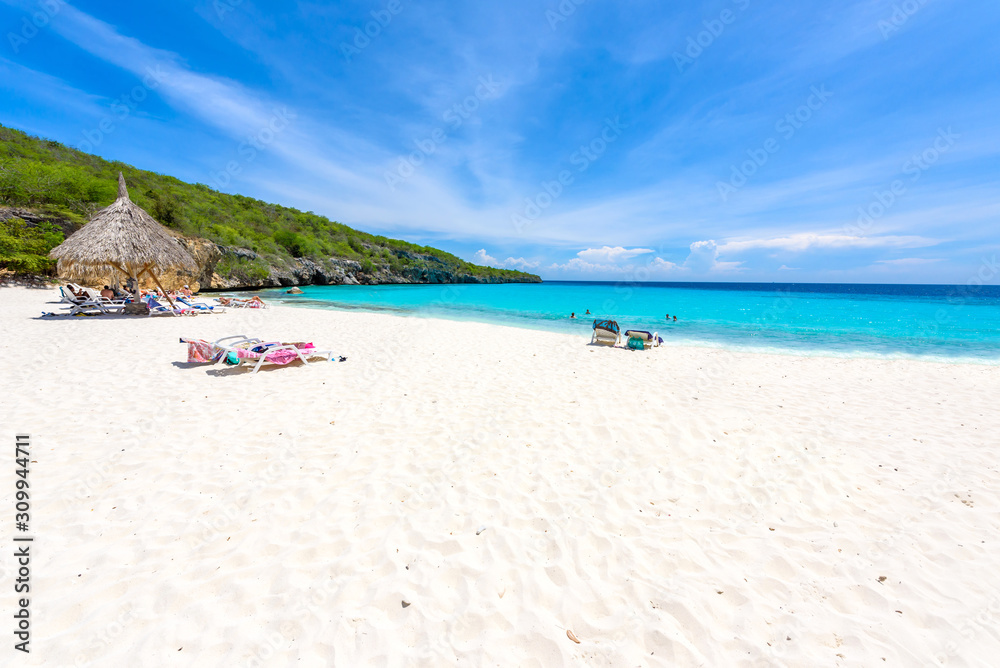 Cas Abao beach - paradise white sand Beach with blue sky and crystal clear blue water in Curacao, Netherlands Antilles, a Caribbean tropical Island Cas Abao beach - paradise white sand Beach with blue sky and crystal clear blue water in Curacao, Netherlands Antilles, a Caribbean tropical Island