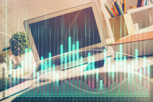 Financial graph colorful drawing and table with computer on background. Double exposure. Concept of international markets. © peshkova