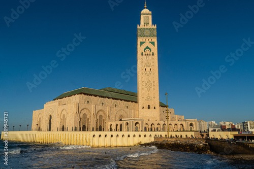 view of Hassan II Mosque against blue sky - The Hassan II Mosque or Grande Mosquée Hassan II is a mosque in Casablanca, Morocco.