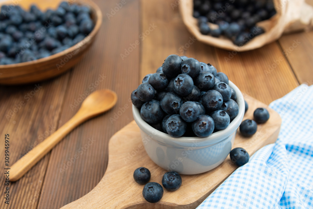 Ripe blueberries in the bowl on the wooden table. Fresh berries for breakfast. Ripe blueberries in the bowl on the wooden table. Fresh berries for breakfast.