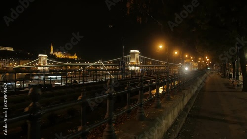 Old tram at night yellow retro city in dark park near the Danube river in Budapest Hungary pedestrian POV camera movement view