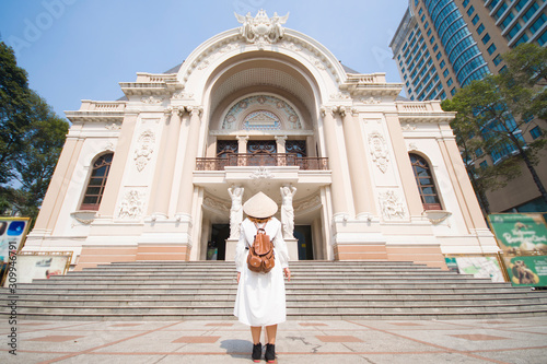 Woman tourist is sightseeing at The Saigon Opera House in Ho Chi Minh is an elegant colonial building at the intersection of Le Loi and Dong Khoi Street. © BUSARA