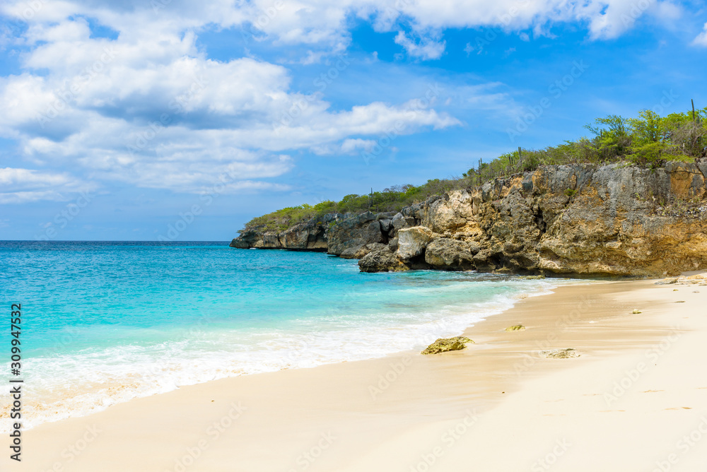 Little Knip beach - paradise white sand Beach with blue sky and crystal clear blue water in Curacao, Netherlands Antilles, a Caribbean tropical Island