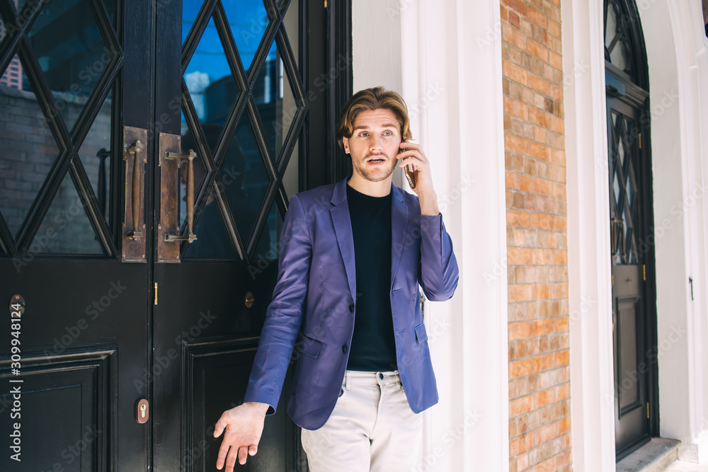 Fototapeta premium Bewildered man answering phone call