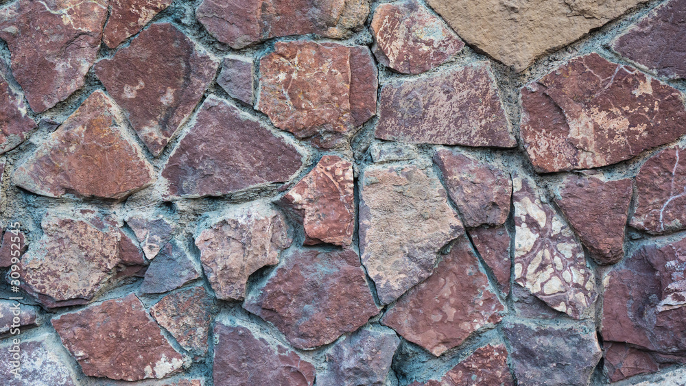 the structure of the old stone wall close up