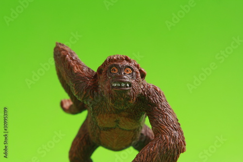 orangutan shaped plastic toy in color background