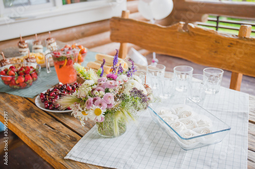 summer party table with fruit cheese and strawberry lemonade