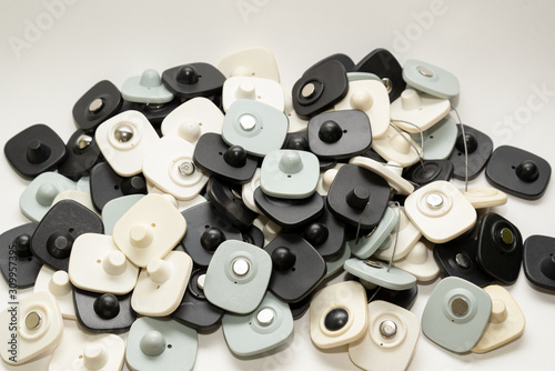 many multi-colored anti-theft sensor on a light background
