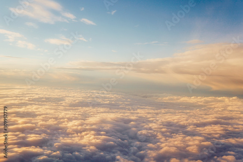 Sunset above the clouds landscape from an airplane journey