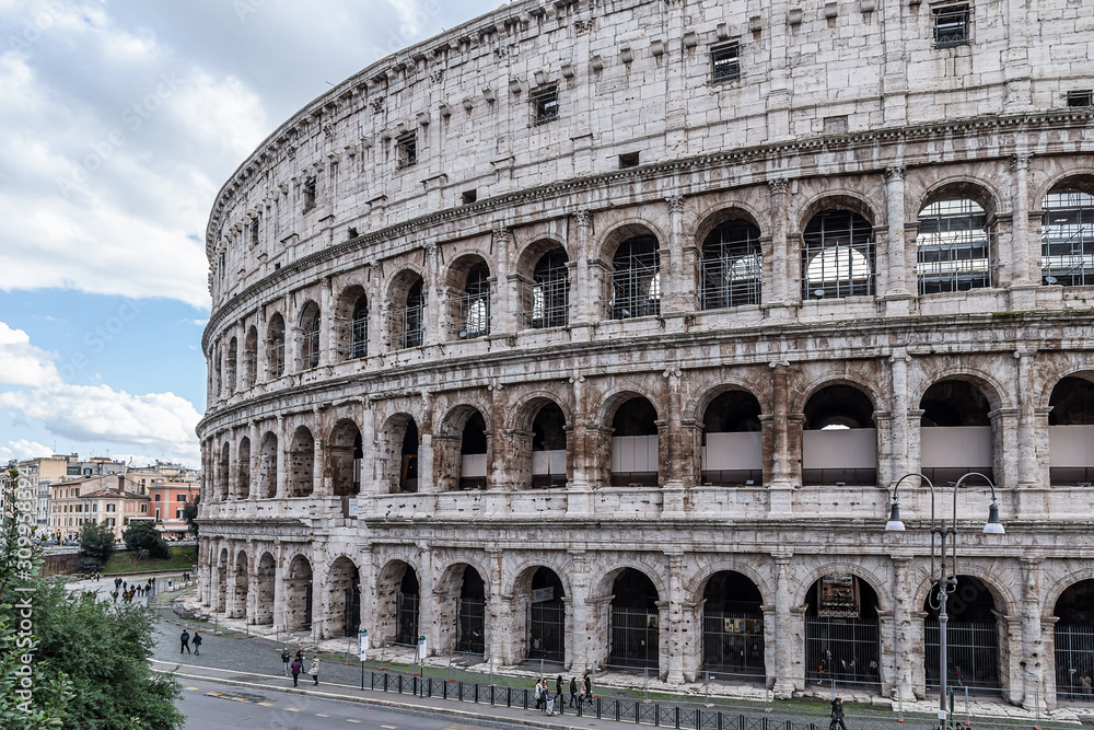 ROME, ITALY - DECEMBER 01, 2019:  Ancient Roman Colosseum, best known architecture and landmark in Rome, Italy. People visit the famous Colosseum in Roma center.