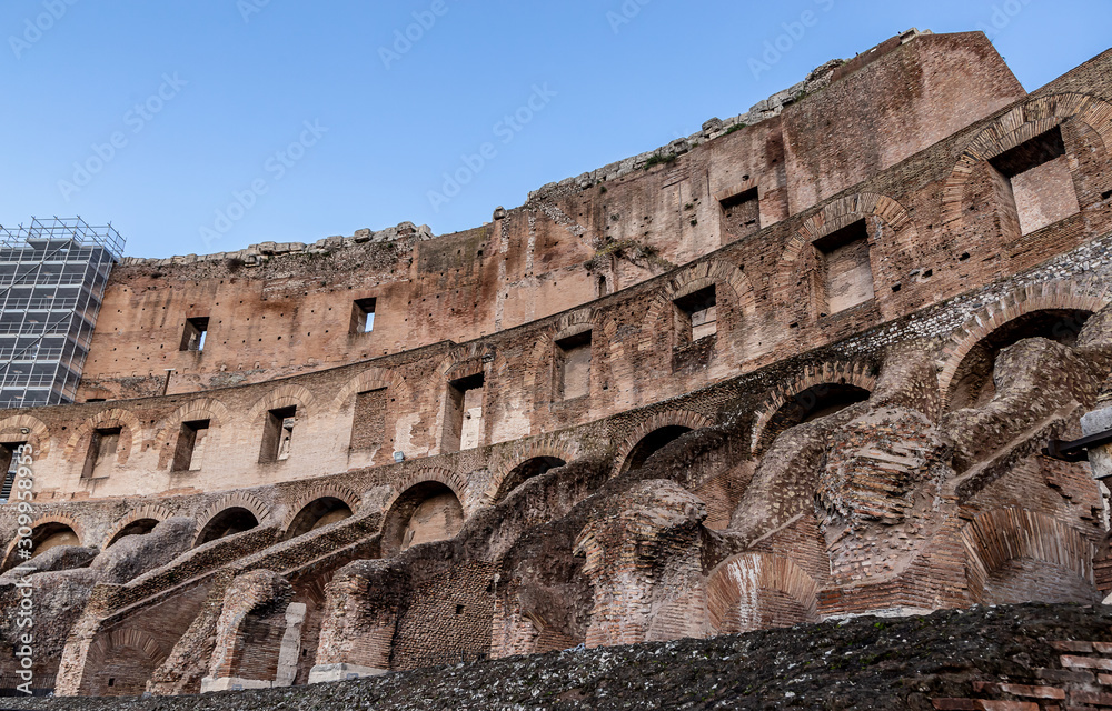 ROME, ITALY - DECEMBER 01, 2019:  Ancient Roman Colosseum, best known architecture and landmark in Rome, Italy. People visit the famous Colosseum in Roma center.