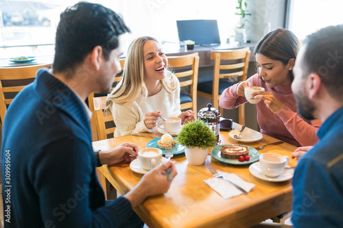 Male And Female Friends Having Fun At Cafe