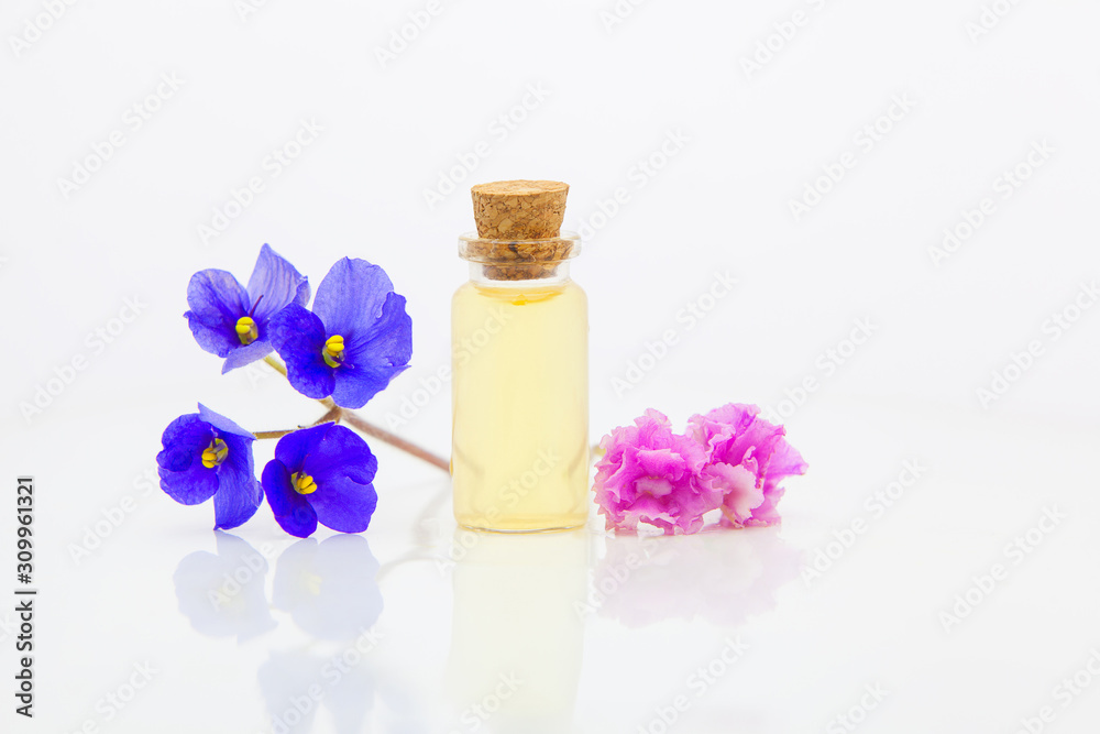 violet essential oil in beautiful bottle on White background violet essential oil in beautiful bottle on White background