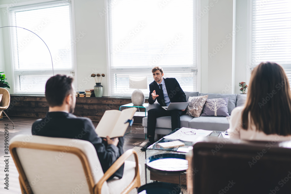 Group of coworkers discussing strategy in office Group of coworkers discussing strategy in office