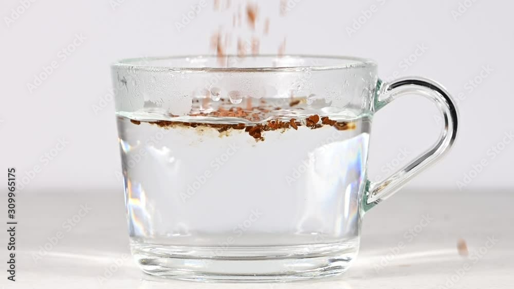 Pouring freeze dried instant coffee in hot water Pouring freeze dried instant coffee in hot water