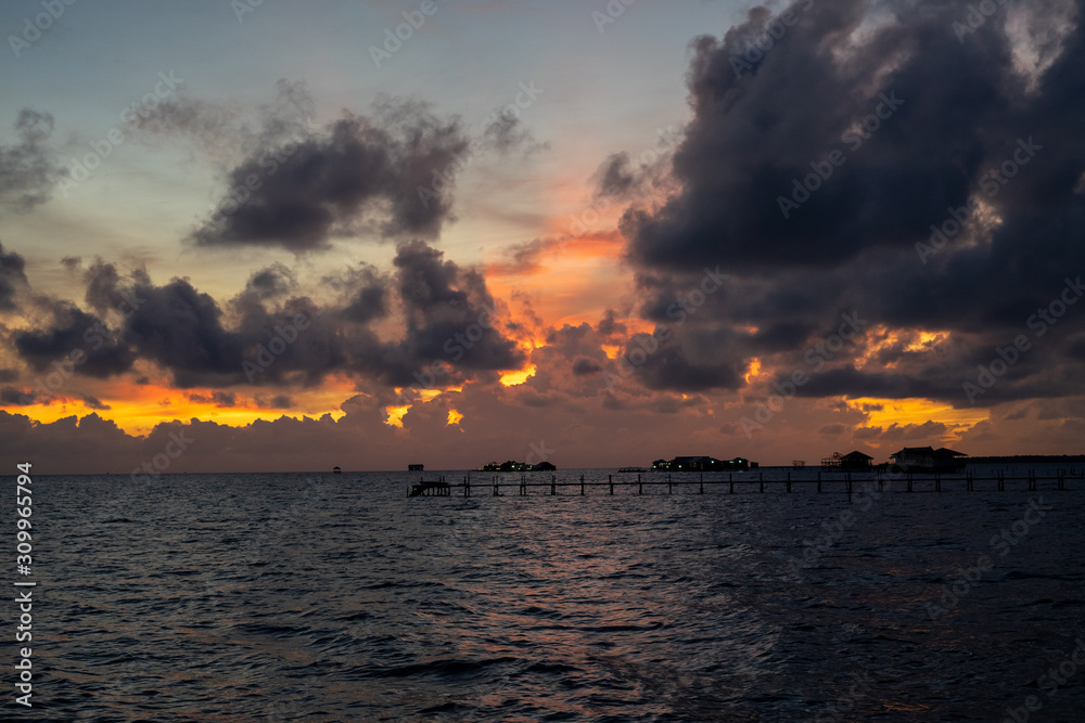 Sunset background and sun beam on the open sea with beautiful clouds. Sunset background and sun beam on the open sea with beautiful clouds.