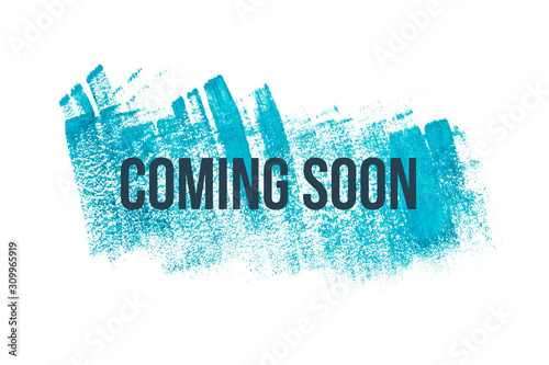 Obraz na płótnie Coming soon on blue paint background, isolated on white