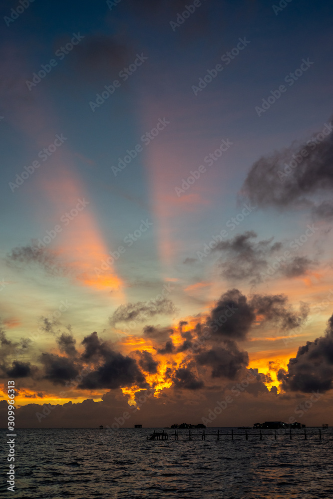 Sunset background and sun beam on the open sea with beautiful clouds. Sunset background and sun beam on the open sea with beautiful clouds.
