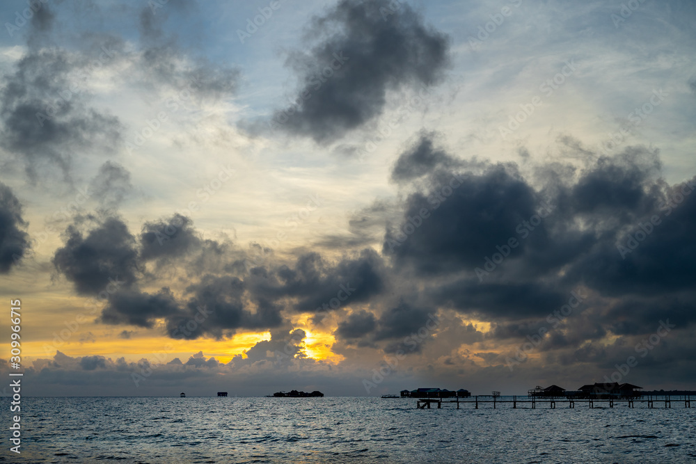 Sunset background and sun beam on the open sea with beautiful clouds. Sunset background and sun beam on the open sea with beautiful clouds.