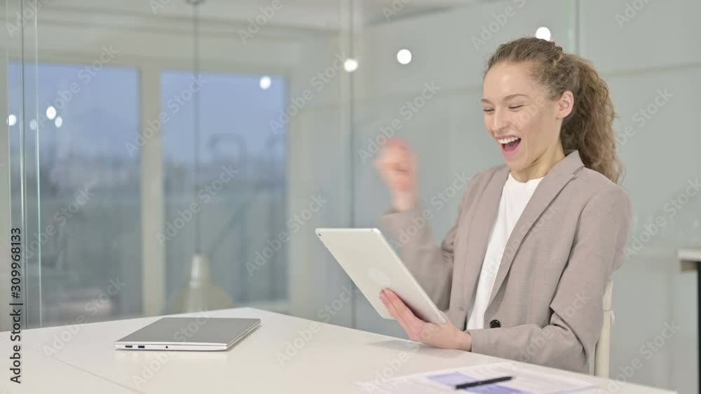 Cheerful Young Businesswoman Celebrating Success on Tablet Cheerful Young Businesswoman Celebrating Success on Tablet