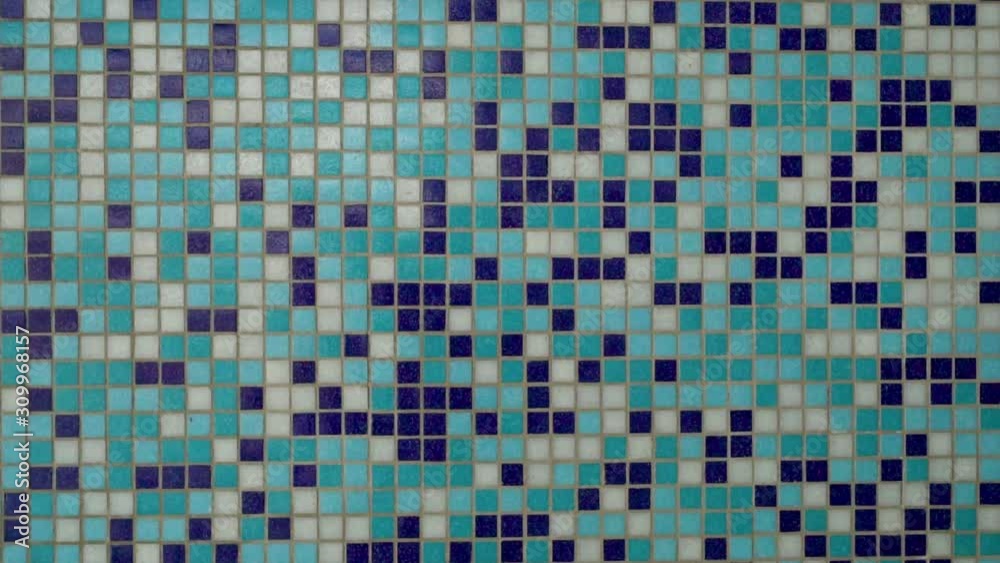 Close-up of blue and white ceramic mosaic in modern interior of pool, bathroom, shower, sliding camera from left to right Close-up of blue and white ceramic mosaic in modern interior of pool, bathroom, shower, sliding camera from left to right