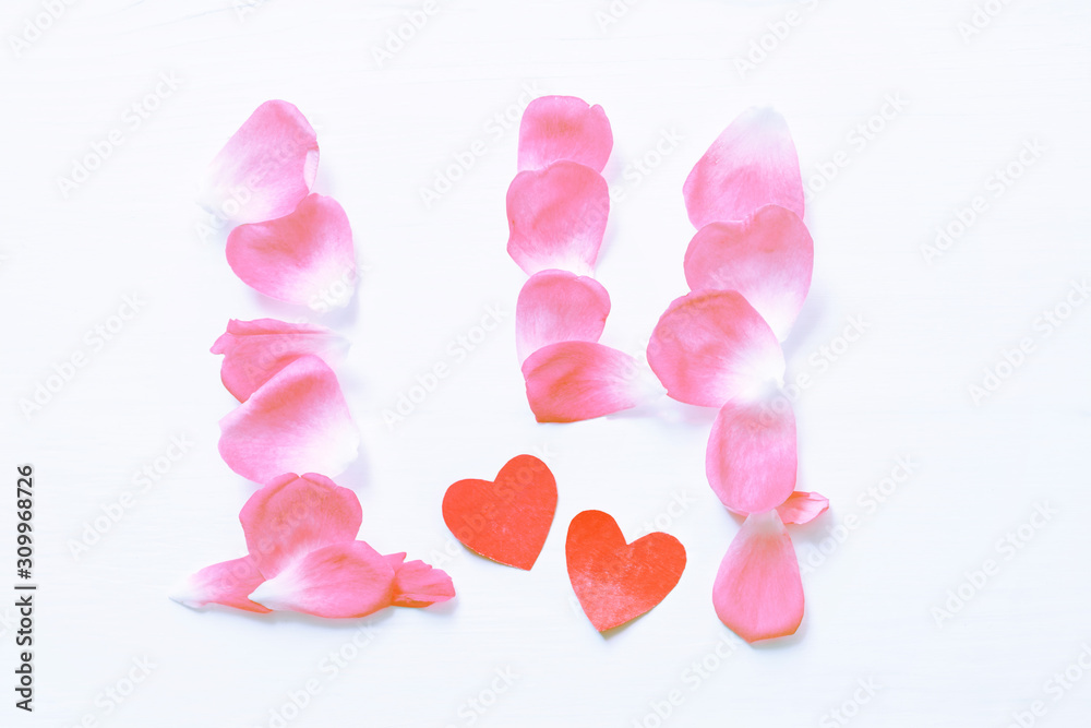 Numeral 14 of rose petals and two red heart symbols on a white surface, top view.  Valentine's Day Greeting Card