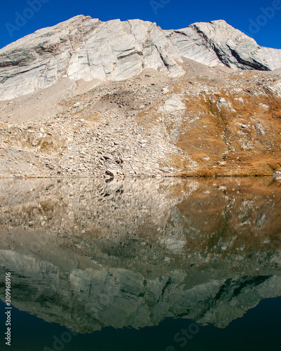 Crete de la Taillante mountain reflected in Foreant lake water. Queyras Regional Park, France. photo