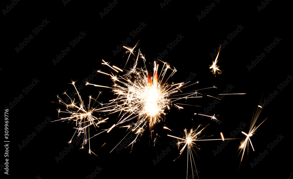 Burning sparkler isolated on black background