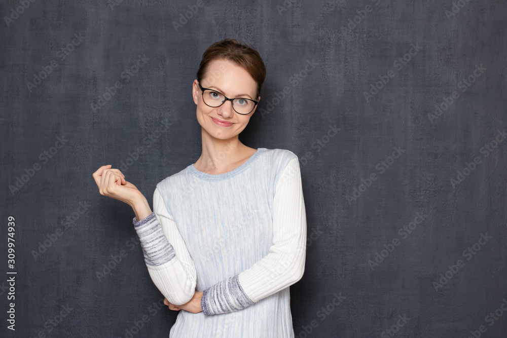 Portrait of happy satisfied young woman standing in relaxed position