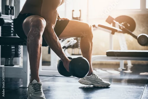 Obraz strong athlete man person exercising in the sport gym, workout exercise training in fitness for body strong and fit, bodybuilding and healthy lifestyle people