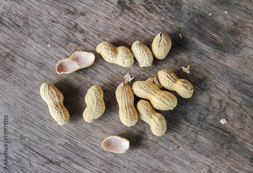 Group of peanuts in shells on old wood background