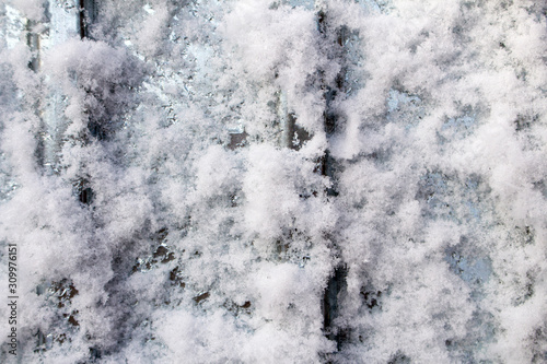 Snow frost on metal. A sheet of metal in the cold was covered with the texture of blue frost. © VIKTOR