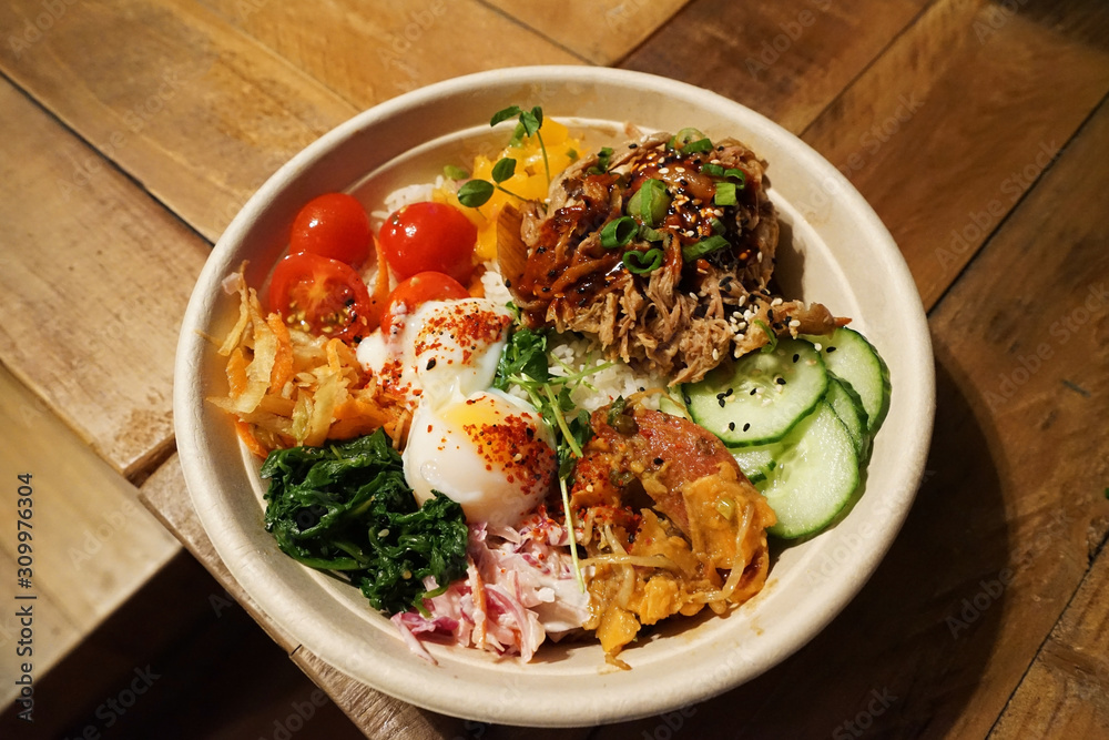 Close up bowl of Barbecue pulled beef on rice with mixed vegetables in Korean style Close up bowl of Barbecue pulled beef on rice with mixed vegetables in Korean style