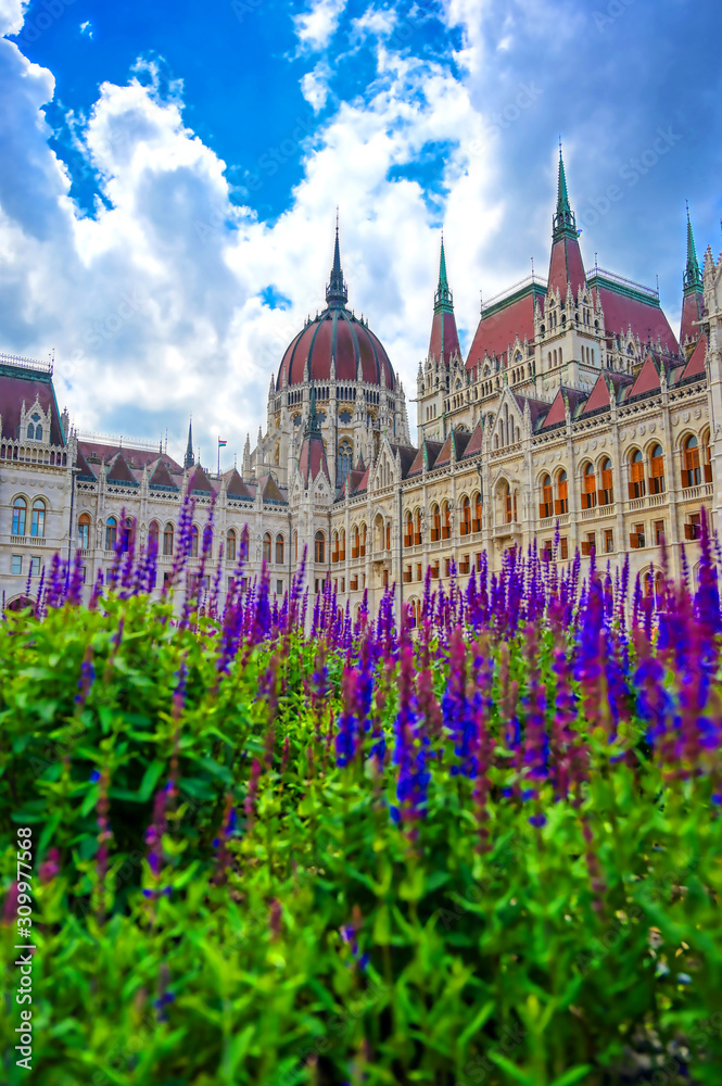 The Hungarian Parliament Building located on the Danube River in Budapest Hungary at sunset.