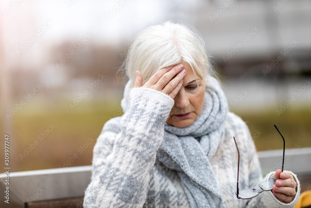 Senior woman suffering from a headache Senior woman suffering from a headache