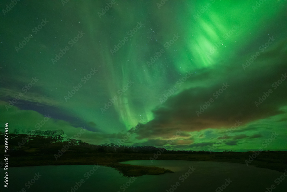 Northern lights over a lake in winter in Iceland