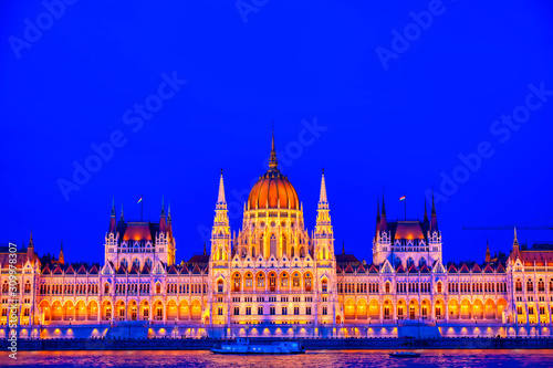 The Hungarian Parliament Building located on the Danube River in Budapest Hungary at sunset. © Jbyard