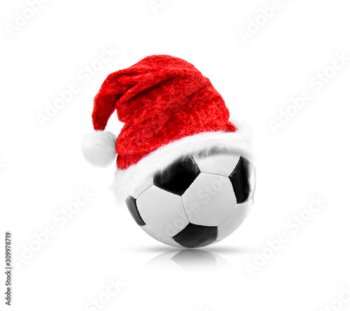 Rote Weihnachtsmütze auf Fußball vor weißem Hintergrund