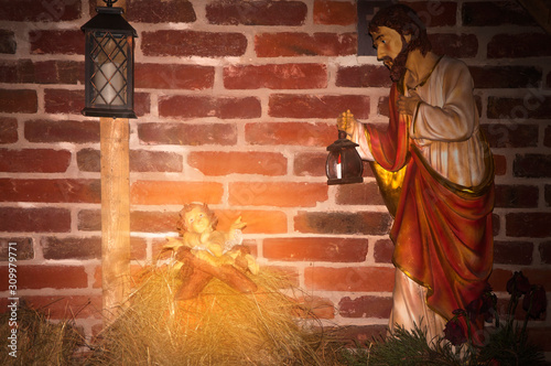 Fragment of religious nativity scene. Newborn Jesus with Joseph