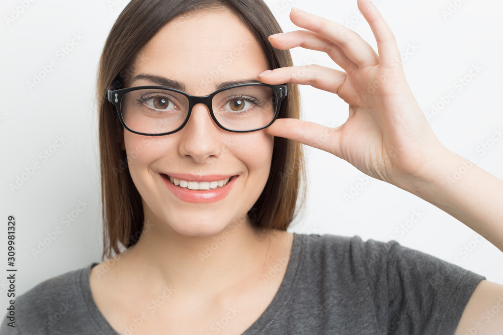 Smiling young woman in glasses on a white background. Smiling young woman in glasses on a white background.