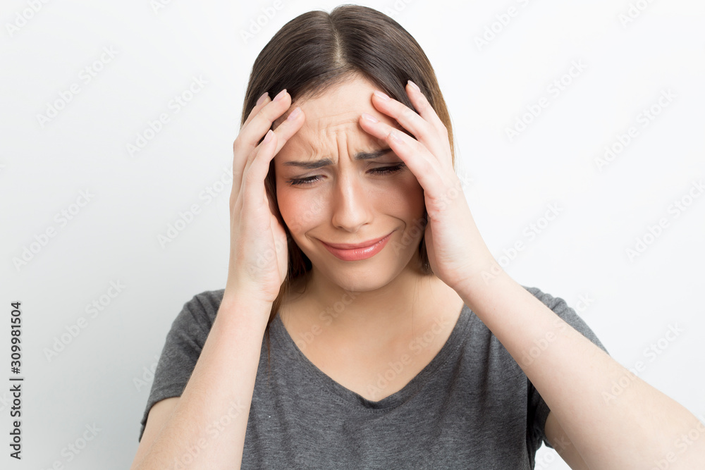 Headache, fatigue, stress in a woman. The depressive state of a girl on a white background. Headache, fatigue, stress in a woman. The depressive state of a girl on a white background.