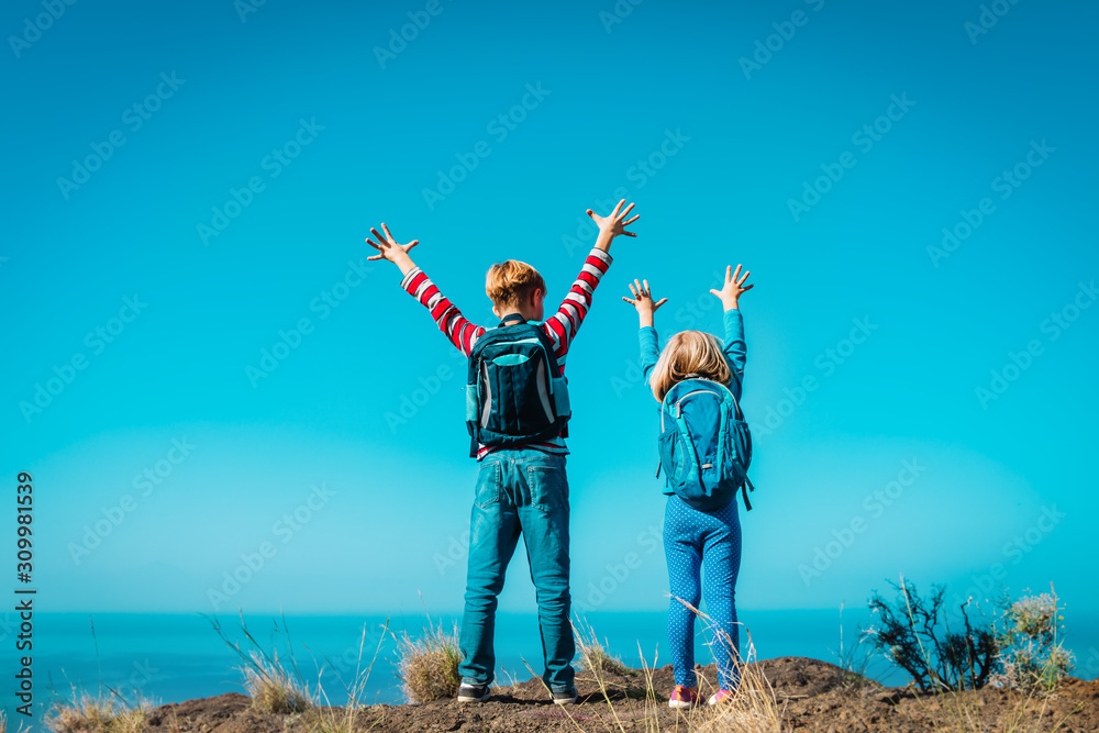© nadezhda1906 - happy boy and girl enjoy travel in mountains near sea