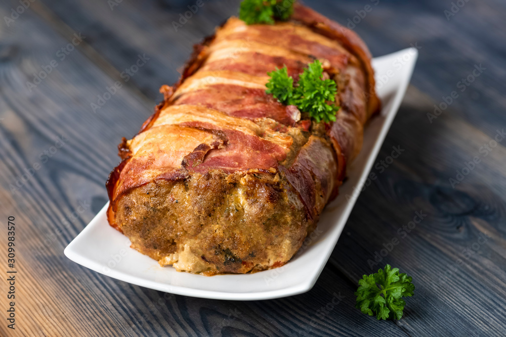 baked roulade of minced meat surrounded by bacon