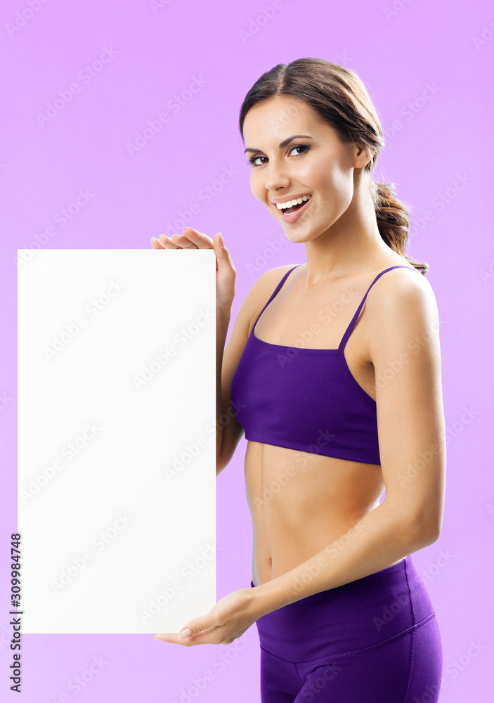 Fitness, sport, training and healthy lifestyle concept - young woman in fitness wear showing blank signboard or copyspace, on rose background Fitness, sport, training and healthy lifestyle concept - young woman in fitness wear showing blank signboard or copyspace, on rose background