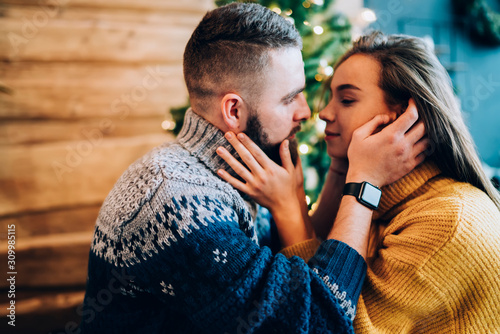 Delighted couple petting in cozy sweaters
