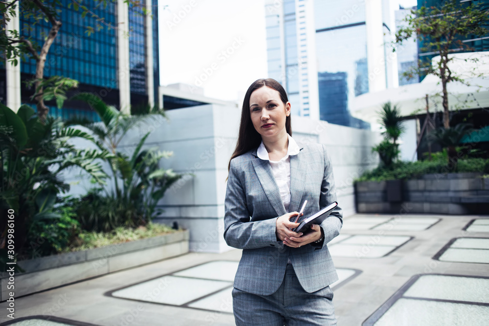 Fototapeta premium Lady in suit standing on street